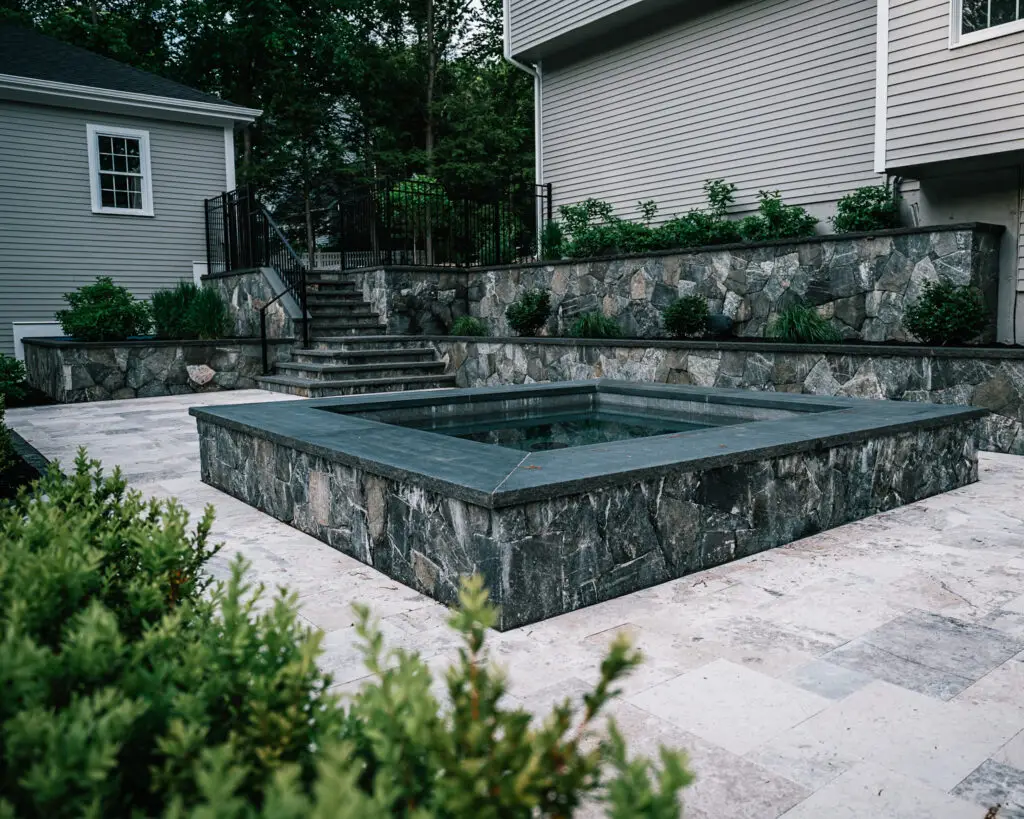 photo of a backyard spa done with natural stones