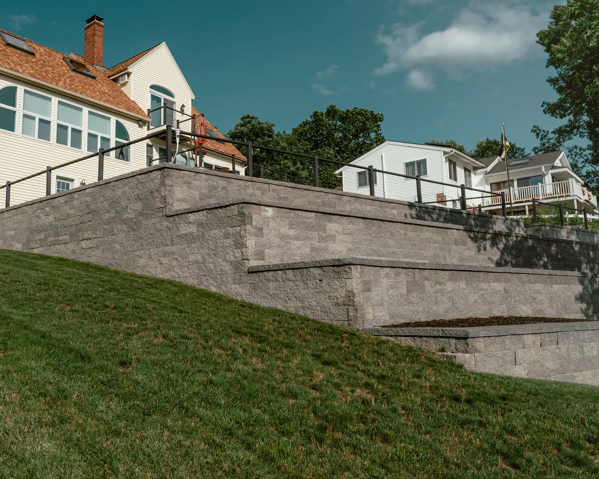 a backyard with a huge retaining wall