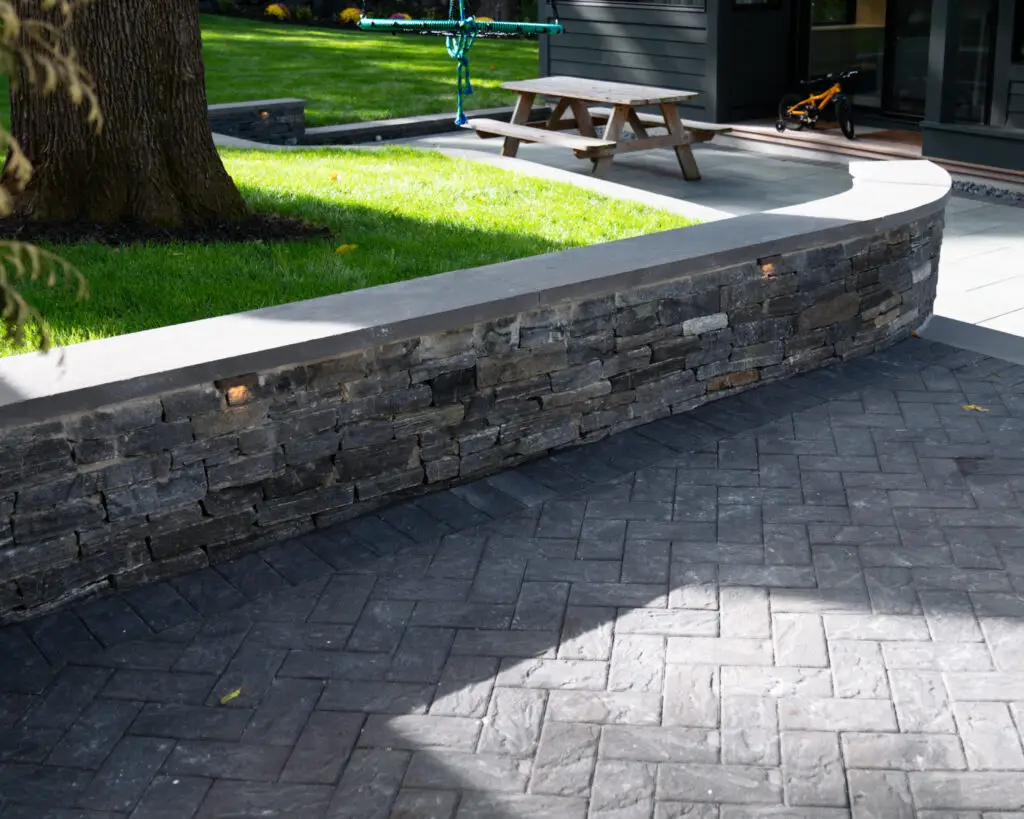 A small retaining wall on a backyard patio