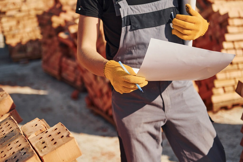 image of a contractor holding a pen and a paper