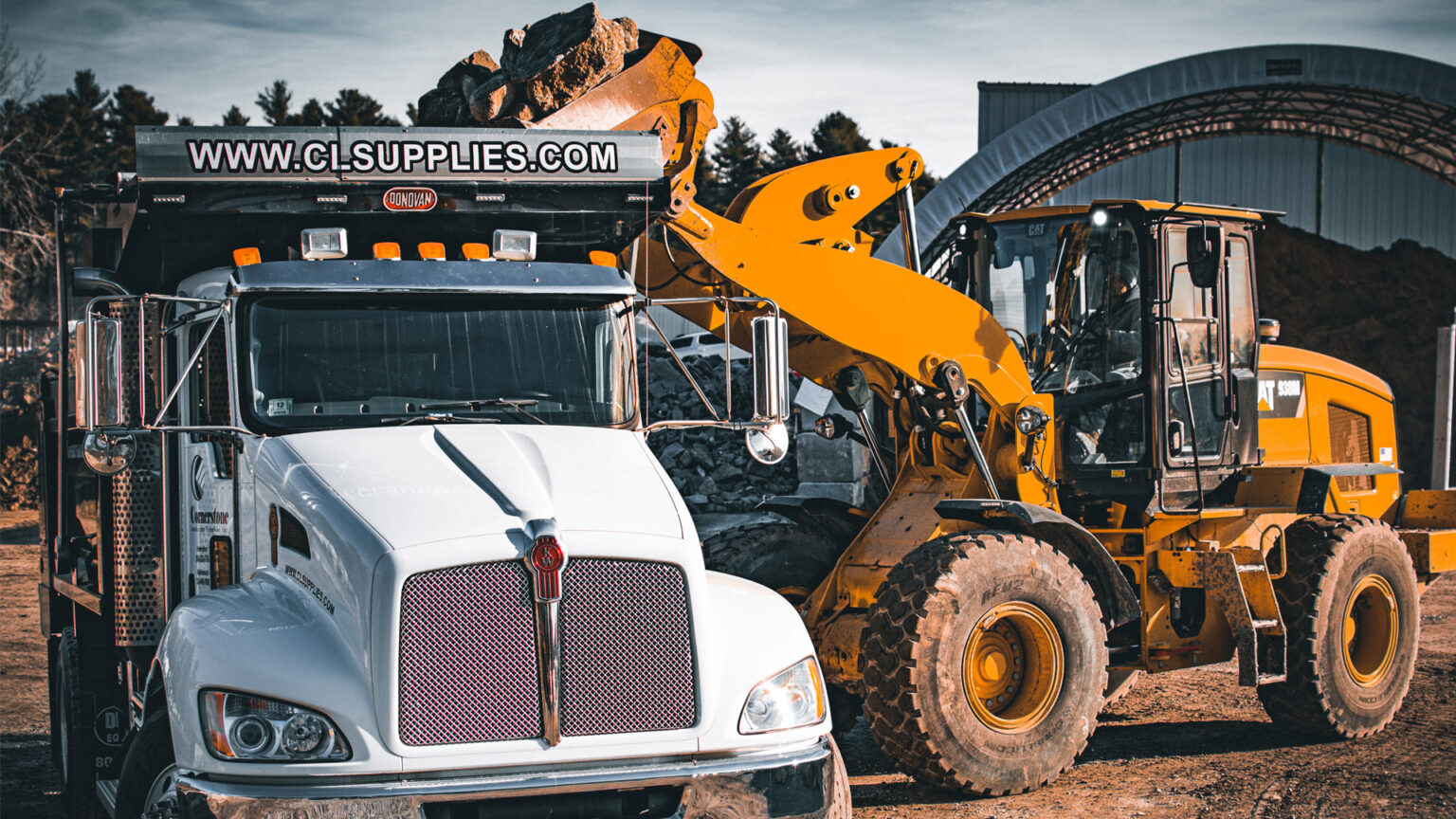 photo of a front loaders loading a truck with natural stones