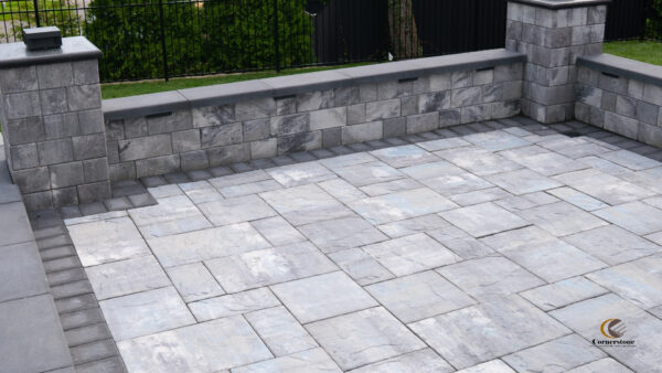 Photo of a seating wall and a patio created with Cambridge pavers